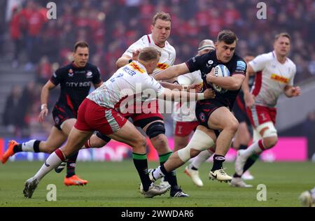 Saracens' Theo Dan is tackled by Harlequins' Lucas Schmid during the ...