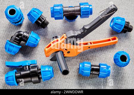 PP connection fitting for compression pipe connectors with pipe cutter. Stock Photo