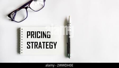 PRICING STRATEGY text on notepad on white background, business concept Stock Photo