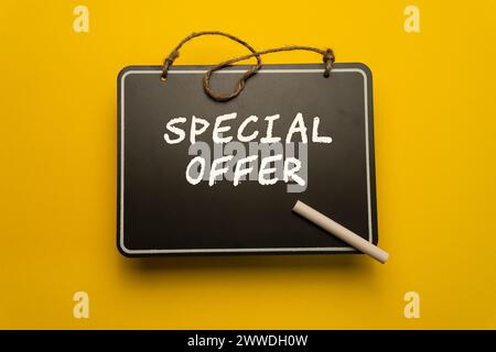 A small chalkboard for schedules on orange background with special offer words Stock Photo