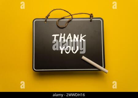 A small chalkboard for schedules on orange background with thank you words Stock Photo