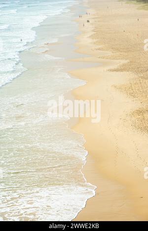 Gold Coast Skyline With People Walking On Beach, Gold Coast, Queensland, Australia Stock Photo