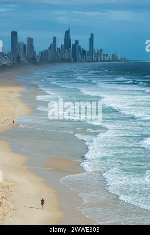 Gold Coast Skyline With People Walking On Beach, Gold Coast, Queensland, Australia Stock Photo