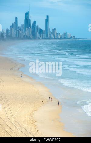 Gold Coast Skyline With People Walking On Beach, Gold Coast, Queensland, Australia Stock Photo