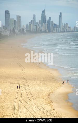 Gold Coast Skyline With People Walking On Beach, Gold Coast, Queensland, Australia Stock Photo