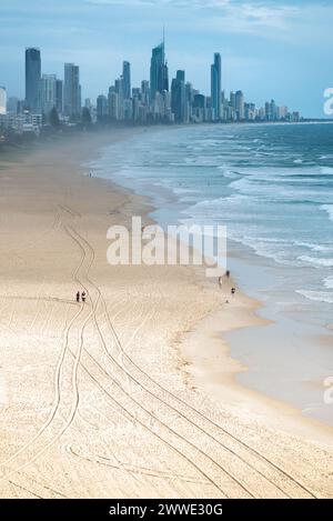 Gold Coast Skyline With People Walking On Beach, Gold Coast, Queensland, Australia Stock Photo