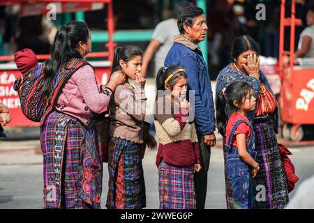 Antigua, Guatemala. 23rd Mar, 2024. An indigenous Mayan family waits in line to attend the vigil of buried Jesus before Palm Sunday at the Santuario San Felipe de Jesús, March 23, 2024 in Antigua, Guatemala. The opulent processions, detailed alfombras and centuries-old traditions attract more than 1 million people to the ancient capital city. Credit: Richard Ellis/Richard Ellis/Alamy Live News Stock Photo