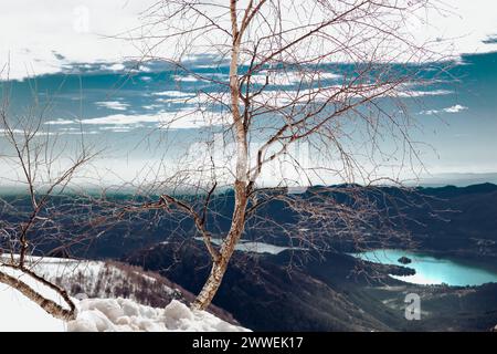 Suggestive view from Mottarone mountain on a winter morning, with lake Orta and snowed mountains. Piedmont - Italy. Stock Photo