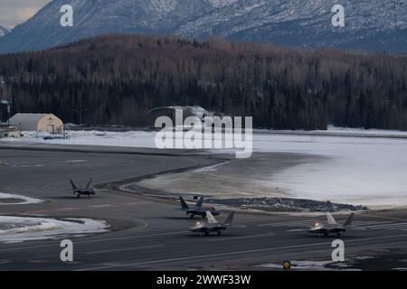 Members of the 3rd Wing and 90th Fighter Generation Squadron prepare to conduct a missing man formation flyover in remembrance of Staff Sgt. Charles A. Crumlett at Joint Base Elmendorf-Richardson, Alaska, March 22, 2024. The missing man formation is a military tradition which dates back to World War II and is one of the highest forms of paying respects to fallen service members. (U.S. Air Force photo by Senior Airman Julia Lebens) Stock Photo