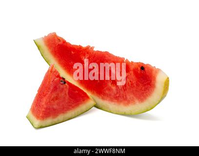 Cut red ripe watermelon with green rind into small pieces of different sizes with black seeds on white background. Professional studio macro photo Stock Photo