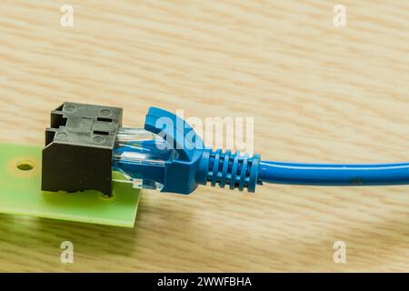 Closeup of blue ethernet cables plugged in homemade ethernet cable connector Stock Photo