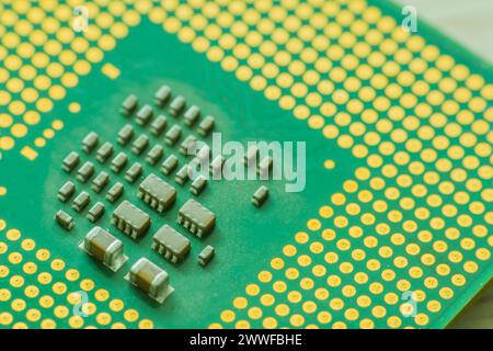 Extreme closeup of Central processor unit (CPU) detailing the individual chips and gold connection pins Stock Photo