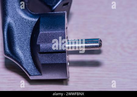 Closeup of computer power cord plug that plugs into electrical socket Stock Photo