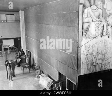 New York, New York, May 10, 1933 A large burlap screen hides from view the partly finished paintings on the walls of the lobby of the new 72-story RCA building in Rockefeller Center, New York. The paintings are the work of Diego Rivera, noted Mexican artist, who was ejected by Rockefeller center, because of supposedly communistic leanings evident in the brilliant colored murals. Stock Photo