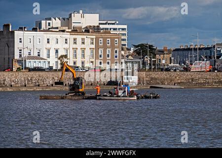 Dredging to remove excess mud from the Marine Lake in Weston-super-Mare, UK on 26 February 2024. Weston-super-Mare is situated on the Bristol Channel, which has one of the highest tidal ranges in the world, and regular dredging is required to ensure that the Marine Lake remains usable for swimming. Stock Photo