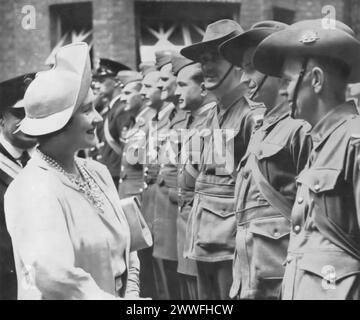 A photograph taken in 1940 captures Queen Elizabeth I (the Queen Mother) greeting Australian troops stationed in Britain during the Second World War. This image highlights her role in boosting morale and strengthening the bonds between the UK and its Commonwealth allies, showcasing her active involvement in the war effort by personally acknowledging the contributions and sacrifices of soldiers far from home. Stock Photo