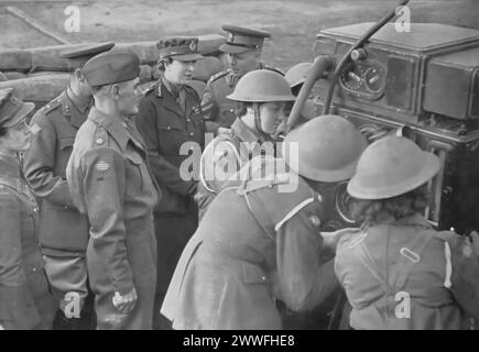 A photograph captures the Princess Royal visiting a mixed Anti-Aircraft (A.A.) battery in Scotland during the Second World War, taken circa 1940. This visit highlights her support and recognition of the military's efforts, showcasing the direct engagement of the royal family with the defense units protecting the United Kingdom during a critical period of the conflict. Stock Photo