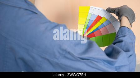Close-up of painter man with color swatches in your hand. Stock Photo