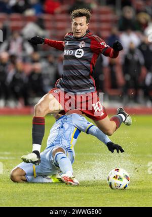 Toronto, Canada. 23rd Mar, 2024. Federico Bernardeschi (front) of Toronto FC jumps to avoid a slide tackle during the 2024 Major League Soccer (MLS) match between Toronto FC and Atlanta United FC in Toronto, Canada, March 23, 2024. Credit: Zou Zheng/Xinhua/Alamy Live News Stock Photo