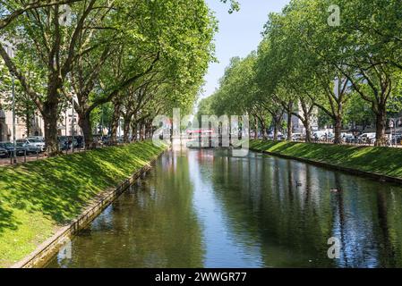 Dusseldorf, Germany - June 1, 2023: Street view at day with Canal and Bridge at Konigsallee in Dusseldorf, North Rhine-Westphalia, Germany. Stock Photo