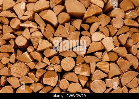 Woodpile of stacked firewood and cut wooden logs for fireplace background Stock Photo