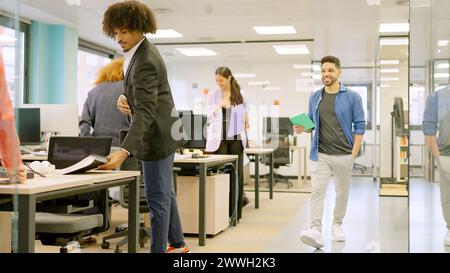 Coworkers arriving at a modern office in the morning Stock Photo