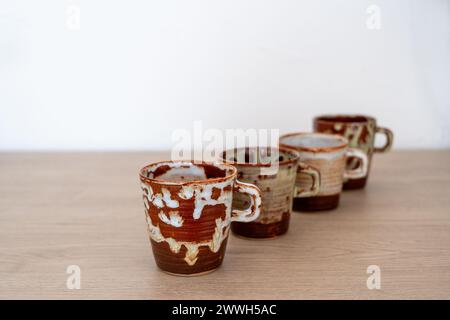 Four handmade ceramic glazed coffee cups. High quality photo Stock Photo