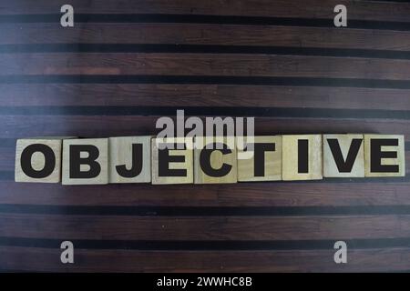 Concept of The wooden Cubes with the word Objective on wooden background. Stock Photo