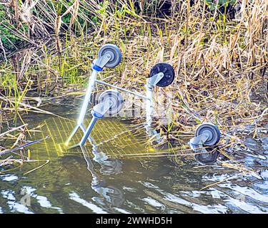 Glasgow, Scotland, UK. 24th March, 2024: UK Weather: Sunny spring weather in the city saw  the forth and clyde canal play host to a shopping trolley. Credit Gerard Ferry/Alamy Live News Stock Photo