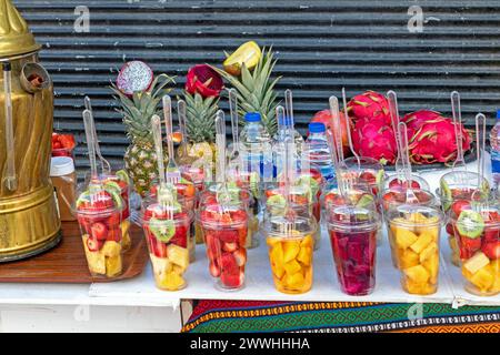 Fresh raw cut organic colorful fruits inside plastic cups sold on market Stock Photo