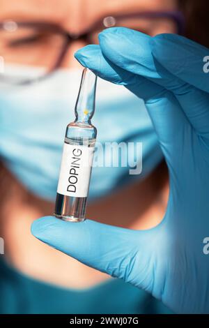 A doping ampoule in a nurse s hand A doping ampoule in a nurse s hand closeup photo, sports doping addiction concept Li A doping ampoule in a nurse s Stock Photo