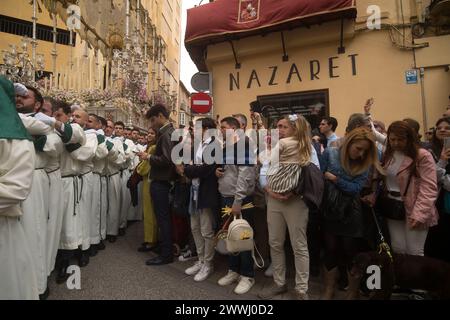 Malaga, Spain. 24th Mar, 2024. People are seen looking the statue of the Virgin from 'Pollinica' brotherhood during the Palm Sunday, to mark the Holy Week celebrations. Thousands of worshippers wait to see the processions with the statues of Christ and the Virgin Mary as part of the traditional Holy Week celebrations. In Andalusia, Easter brings together thousands of people from all over the world and it's considered one of the most important religious and cultural events of the year. (Photo by Jesus Merida/SOPA Images/Sipa USA) Credit: Sipa USA/Alamy Live News Stock Photo