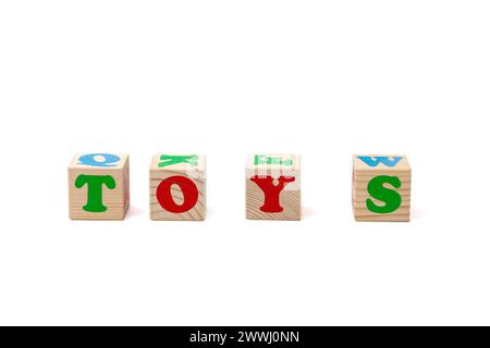 Children's wooden cubes with red and green letters with the word toy lying next to them. Isolate. High quality photo. Stock Photo