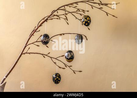 colorful painted easter eggs hanging on a twig, Bavaria, Germany - March 2024 Stock Photo