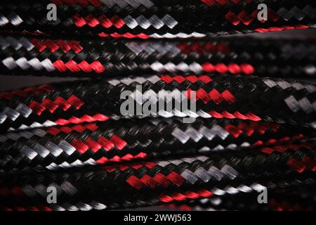 Abstract background with cable in black and white and red cloth braid Stock Photo