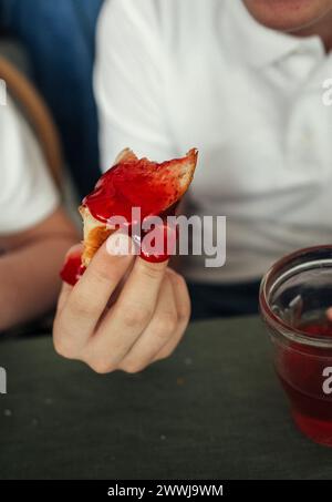 A persons hand holding a piece of food in a close-up shot. Stock Photo