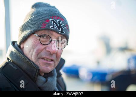 Man wearing cap and glasses Rotterdam, Netherlands. Middle aged man wearing cap and glasses working outside in cold, winter weather. MRYES Rotterdam Rijnhaven, pier Zuid-Holland Nederland Copyright: xGuidoxKoppesx Stock Photo
