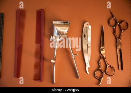 Various barber's tools isolated on brown background Stock Photo