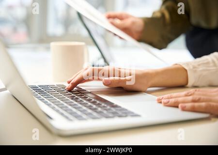 Unrecognizable clothing designer and assistant working together Stock Photo