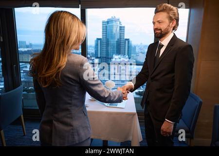 Elegant businessman shaking hands with a woman Stock Photo