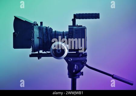 Video camera rig on a tripod, ready for shooting. Professional type of equipment, symbol of filmaking industry and entertainment. Stock Photo
