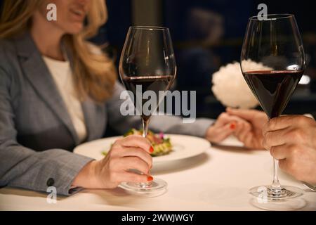 Couple at dinner tenderly holds hands Stock Photo