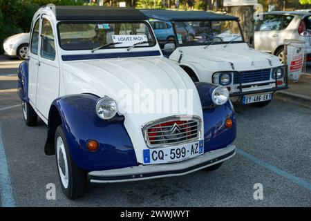 Le Lavandou, Provence, France - June 21 2021: Historic iconic car Citroen 2CV (duck) with blue and white colour parked in historic french riviera town Stock Photo