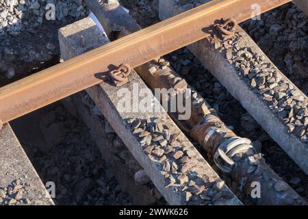 Pipe damaged by tamper packing ballast under sleepers that may have contributed to the sink-hole which caused the train accident at Grange Over Sands Stock Photo