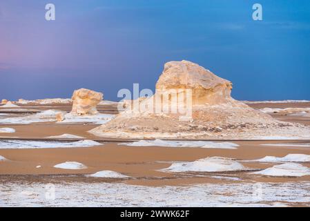 Wind-carved chalk rock formations at dusk in the White Desert, Egypt Stock Photo