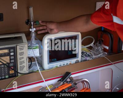 Emergency care workers turn on the ventilator in the ambulance. Stock Photo