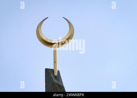 golden crescent on the top of a minaret of a mosque in germany Stock Photo