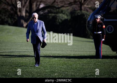 Washington, United States. 24th Mar, 2024. US President Joe Biden walks on the South Lawn of the White House after arriving on Marine One in Washington, DC, US, on Sunday, March 24, 2024. Biden on Saturday signed a $1.2 trillion funding package that keeps the US government running through Sept. 30, averting a partial shutdown. Photographer: Ting Shen/Pool/Sipa USA Credit: Sipa USA/Alamy Live News Stock Photo