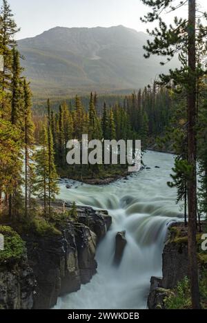 Sunwapta Falls in the stunning Canadian Rockies at sunrise in summertime with beautiful cascading waterfall in popular tourist, landscape area Canada. Stock Photo