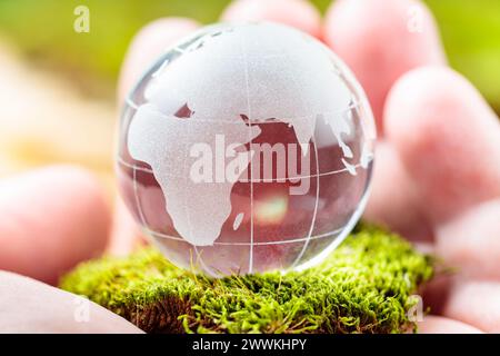 Glass Globe Cradled in Man's Palm, Earth Day and Environmental Conservation Stock Photo